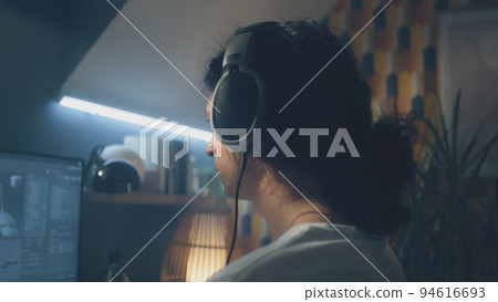 Man in headphones surfing the internet on pc Man in headphones surfing the internet on pc 94616693