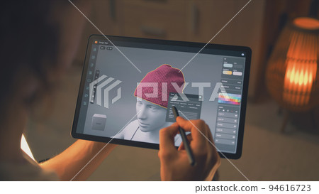 Guy designing clothes in app on tablet Guy designing clothes in app on tablet 94616723