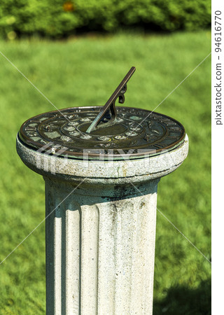 antique sundial on a pedestal in sunny day in garden, New Jersey Botanical Garden antique sundial on a pedestal in sunny day in garden, New Jersey Botanical Garden 94616770