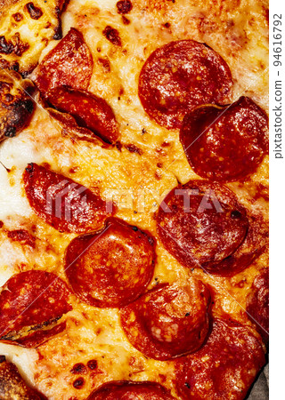 A close up of a slice of pizza 94616792