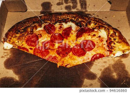 A close up of a slice of pizza 94616860