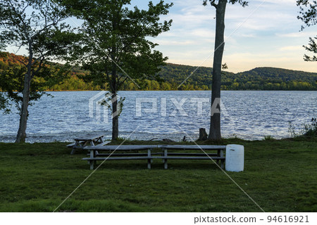 White plastic barrel for garbage in a park near Rockland Lake, New York.  94616921
