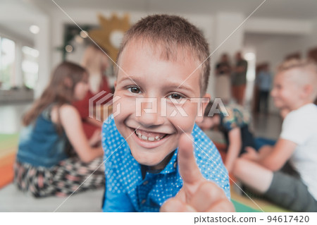 Portrait photo of a smiling boy in a preschool institution having fun 94617420