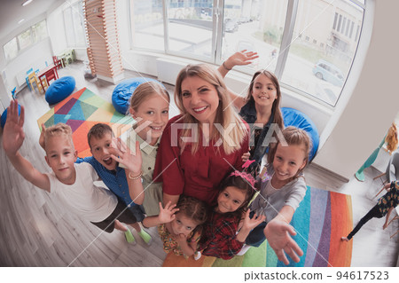 photo of children in a preschool institution standing in the classroom together with the teacher photo of children in a preschool institution standing in the classroom together with the teacher 94617523