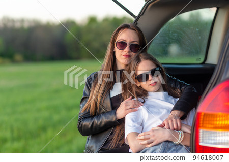 Mother and daughter camping on a hill Mother and daughter camping on a hill 94618007