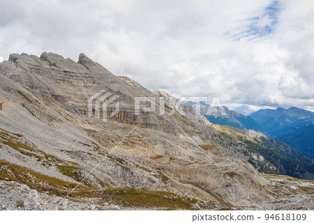 Dolomite rock wall at mountain range. Dolomites UNESCO Italian Alps landscape Dolomite rock wall at mountain range. Dolomites UNESCO Italian Alps landscape 94618109