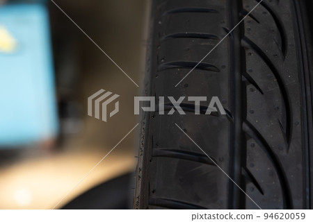 Checking a car wheel, tire repair at car garage 94620059