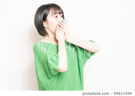 A young woman doing a surprised pose in front of a white background A young woman doing a surprised pose in front of a white background 94621944