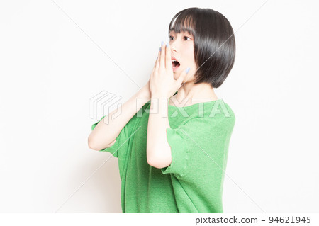 A young woman doing a surprised pose in front of a white background A young woman doing a surprised pose in front of a white background 94621945