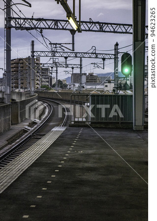 Scenery with a dim railroad track after rain Scenery with a dim railroad track after rain 94623265