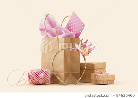 Gift or Sale concept. Shopping paper bag, Crown headband with pink tissue 94626400