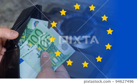 Mens hands with a purse and euro banknotes on the background of a gas stove. Mens hands with a purse and euro banknotes on the background of a gas stove. 94627496