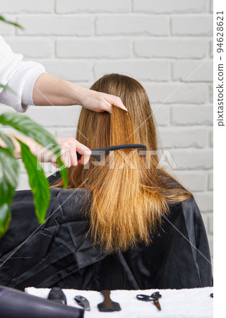 Beautiful girl with long hair. creating a hairstyle for unrecognizable girl. Hair styling process. Beautiful girl with long hair. creating a hairstyle for unrecognizable girl. Hair styling process. 94628621