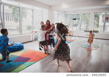 A child hugging a teacher in a modern kindergarten A child hugging a teacher in a modern kindergarten 94629005