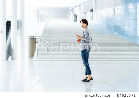 Middle career woman looking at a smartphone 94629571