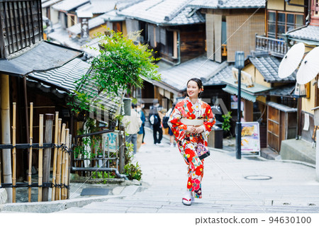 A woman in a kimono walking on the streets of Kyoto 94630100
