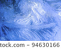 Christmas blue background with frozen pattern on window. 94630166