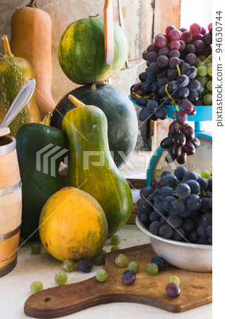 Autumn still life with pumpkins, melons, watermelon, grapes on a wooden white table. Autumn harvest concept. Happy Thanksgiving. Selective focus. Template for design. Autumn still life with pumpkins, melons, watermelon, grapes on a wooden white table. Autumn harvest concept. Happy Thanksgiving. Selective focus. Template for design. 94630744