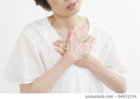 A middle-aged woman feeling palpitations on a white background, no face 94631514