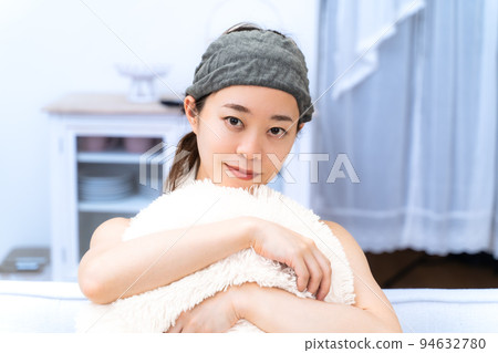 Young woman wearing hair turban at home Young woman wearing hair turban at home 94632780