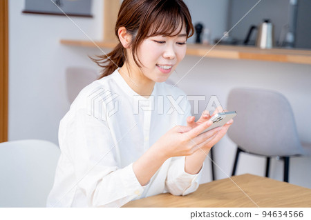 Young woman living room lifestyle smartphone Young woman living room lifestyle smartphone 94634566