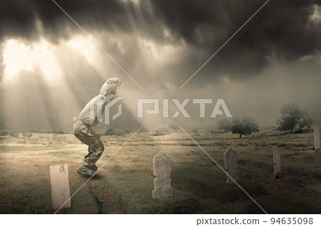 Pocong is covered with a white linen shroud standing 94635098