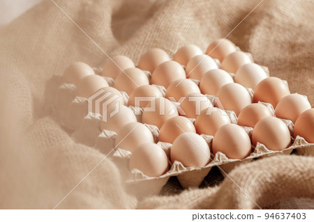 Fresh organic chicken eggs in carton pack or egg paper container on a sacking. Zero waste packaging concept 94637403