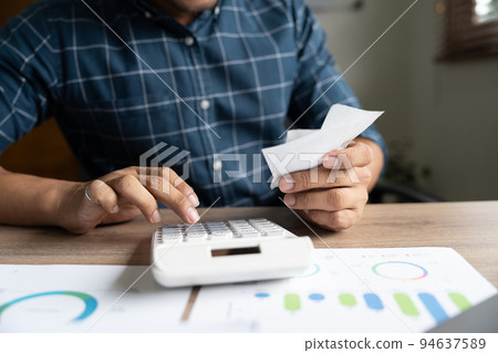 Young asian man calculating expenses household about finance and frustrated on desk at home, male checking bill having stress and worried, debt and tax, expression and emotion, business concept. Young asian man calculating expenses household about finance and frustrated on desk at home, male checking bill having stress and worried, debt and tax, expression and emotion, business concept. 94637589