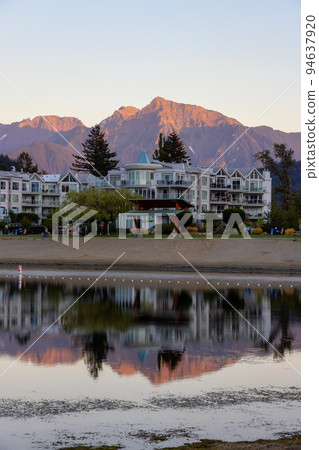 Vacation Homes by the lake and sandy beach. Sunny Summer Morning Sunset Sky 94637920