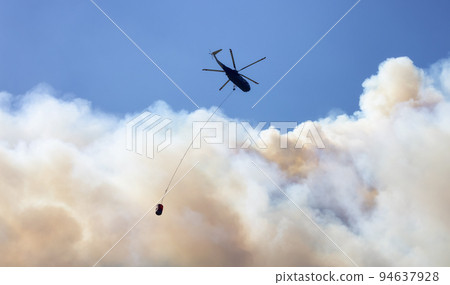 Wildfire Service Helicopter flying over BC Forest Fire and Smoke on the mountain near Hope Wildfire Service Helicopter flying over BC Forest Fire and Smoke on the mountain near Hope 94637928