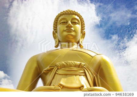 "Phra Buddha Dhammakaya Thep Mongkol" is a Big golden buddha statue made of copper, as tall as a 20-storey building (69 meters), located at Wat Paknam Bhasicharoen. Bangkok, Thailand on a sunny day "Phra Buddha Dhammakaya Thep Mongkol" is a Big golden buddha statue made of copper, as tall as a 20-storey building (69 meters), located at Wat Paknam Bhasicharoen. Bangkok, Thailand on a sunny day 94638169