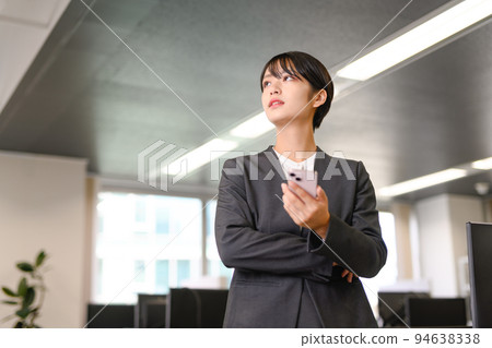 A business person wearing a suit working at work A business person wearing a suit working at work 94638338