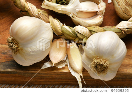 ripe garlic heads and cloves on a rustic wooden background, delicious and healthy food ripe garlic heads and cloves on a rustic wooden background, delicious and healthy food 94639295