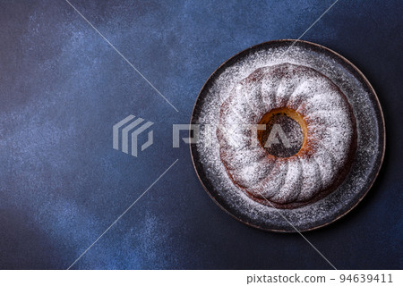 Homemade delicious round Christmas pie with red berries on a ceramic plate 94639411