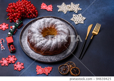 Homemade delicious round Christmas pie with red berries on a ceramic plate 94639425