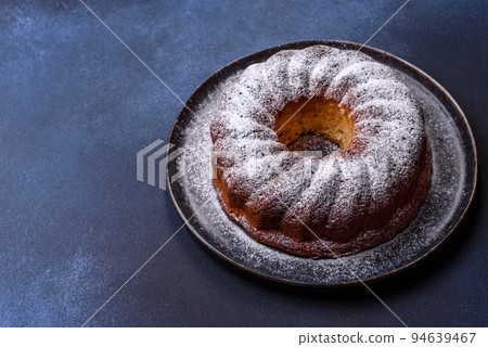 Homemade delicious round Christmas pie with red berries on a ceramic plate 94639467