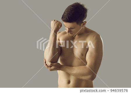 Toned man touch elbow suffer from acute pain 94639576