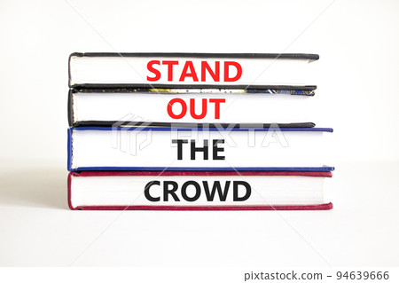 Stand out the crowd symbol. Concept words Stand out the crowd on books on a beautiful white table white background. Business, stand out the crowd concept Stand out the crowd symbol. Concept words Stand out the crowd on books on a beautiful white table white background. Business, stand out the crowd concept 94639666