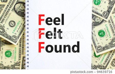 FFF feel felt found technique symbol. Concept words FFF feel felt found on white note on a beautiful background from dollar bills. Psychological FFF feel felt found technique concept. Copy space. 94639716