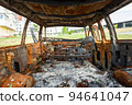Damaged and destroyed civilian car with shrapnel holes from Russian missile in a war zone in Kharkiv, Ukraine 94641047