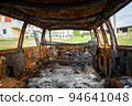 Damaged and destroyed civilian car with shrapnel holes from Russian missile in a war zone in Kharkiv, Ukraine 94641048