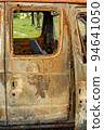 Damaged and destroyed civilian car with shrapnel holes from Russian missile in a war zone in Kharkiv, Ukraine 94641050