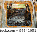 Damaged and destroyed civilian car with shrapnel holes from Russian missile in a war zone in Kharkiv, Ukraine 94641051