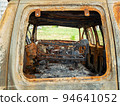 Damaged and destroyed civilian car with shrapnel holes from Russian missile in a war zone in Kharkiv, Ukraine 94641052