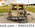 Damaged and destroyed civilian car with shrapnel holes from Russian missile in a war zone in Kharkiv, Ukraine 94641054