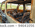 Damaged and destroyed civilian car with shrapnel holes from Russian missile in a war zone in Kharkiv, Ukraine 94641056
