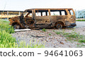 Damaged and destroyed civilian car with shrapnel holes from Russian missile in a war zone in Kharkiv, Ukraine 94641063