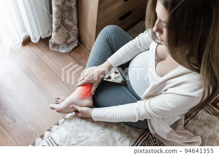 Pregnancy foot ankle pain. Pregnant woman have leg disease, ankle pain doing health massage exercise. Leg cramps during pregnancy. 94641355
