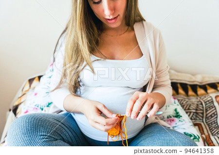 Knitting socks pregnancy woman. Pregnant mother crochet kid cloth. Cute pregnancy woman knit fashion winter baby girl clothes. Cozy knitting woman. 94641358