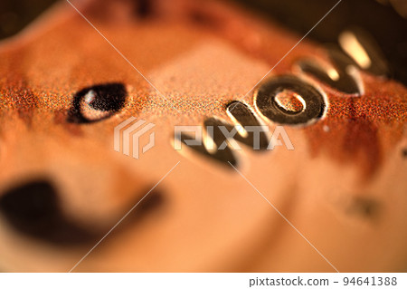 top view extreme macro closeup of doge golden meme coin with shiba dog and the word wow logo 94641388